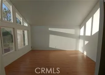 a kitchen with granite countertop stainless steel appliances and wooden floor