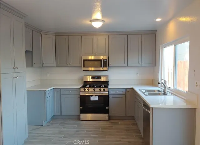 an empty room with wooden floor and a ceiling fan