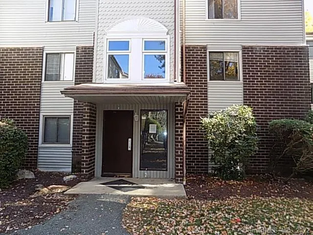 a view of a brick house with large windows