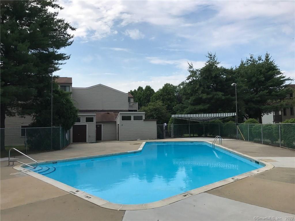 7 Padanaram Road, Unit J238 Danbury, CT 06811 - Photo 3 of 18 a view of a swimming pool with a patio