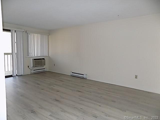 7 Padanaram Road, Unit J238 Danbury, CT 06811 - Photo 4 of 18 a view of a room with wooden floor and white walls