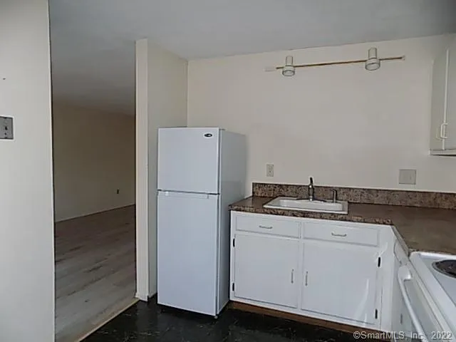 a utility room with cabinets washer and dryer