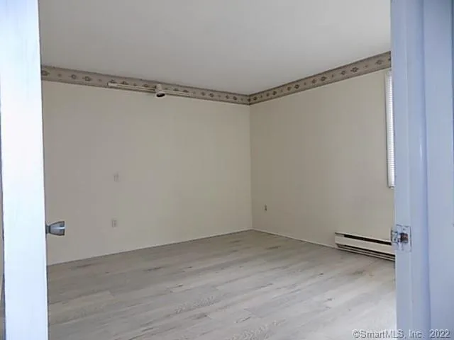 a view of a room with wooden floor