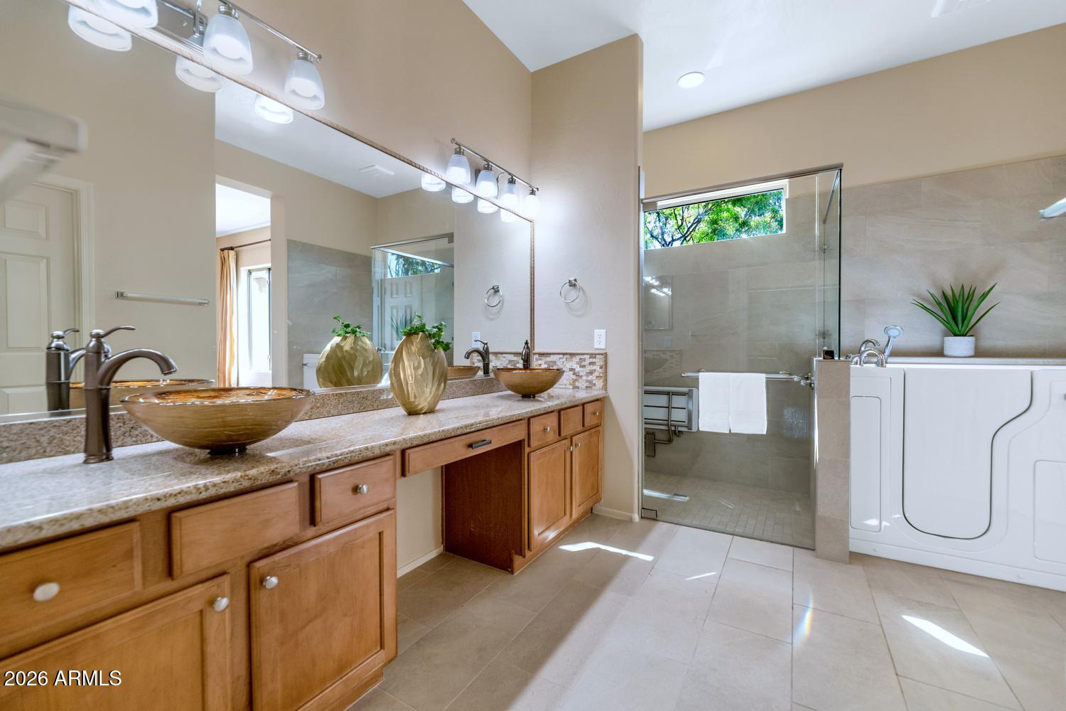 41123 North River Bend Road Phoenix, AZ 85086 - Photo 19 of 45 a spacious bathroom with a double vanity sink a mirror and a bathtub