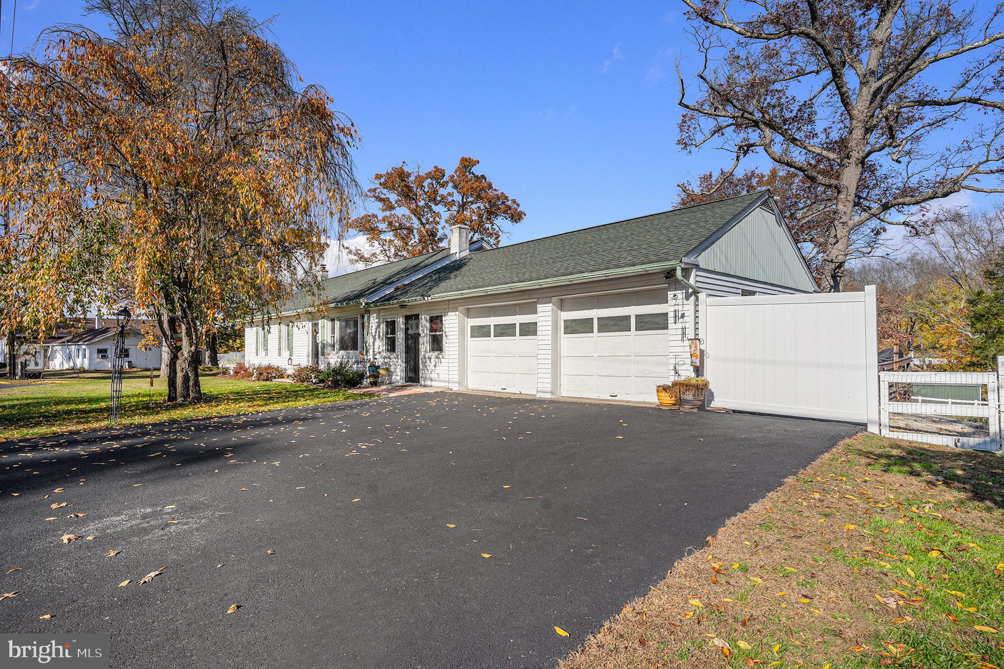 501 Walnut Street Green Lane, PA 18054 - Photo 28 of 28 a view of a house with a large tree and wooden fence