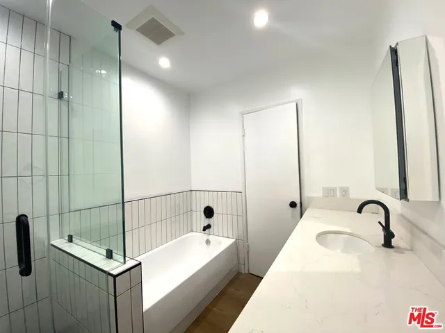 a bathroom with a tub and sink
