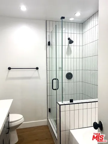 a bathroom with a shower and a toilet