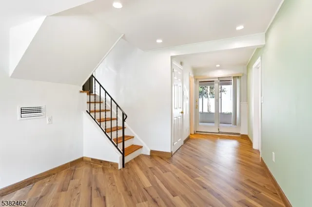 a view of an entryway with wooden floor