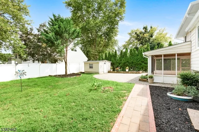 a front view of a house with garden and patio