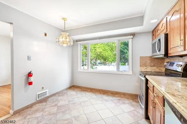 a kitchen that has a cabinets a stove and a window