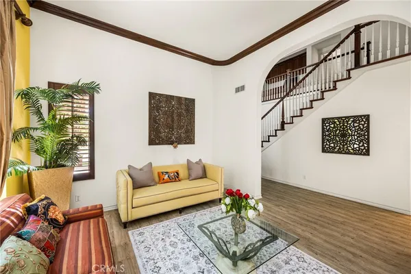 a living room with furniture a flat screen tv and a floor to ceiling window