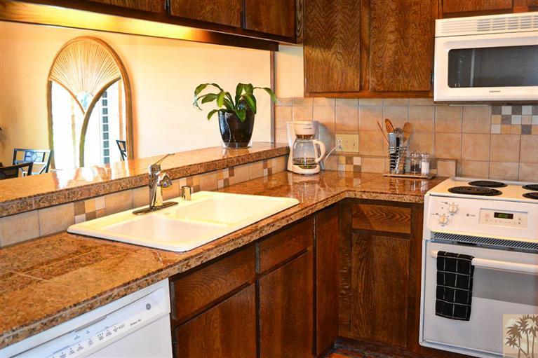 110 South Racquet Club Drive Rancho Mirage, CA 92270 - Photo 7 of 17 a kitchen with a sink stove and cabinets