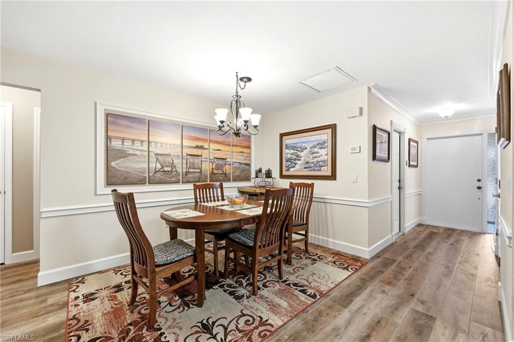 5201 31st Place Southwest Naples, FL 34116 - Photo 11 of 24 a view of a dining room with furniture and a chandelier