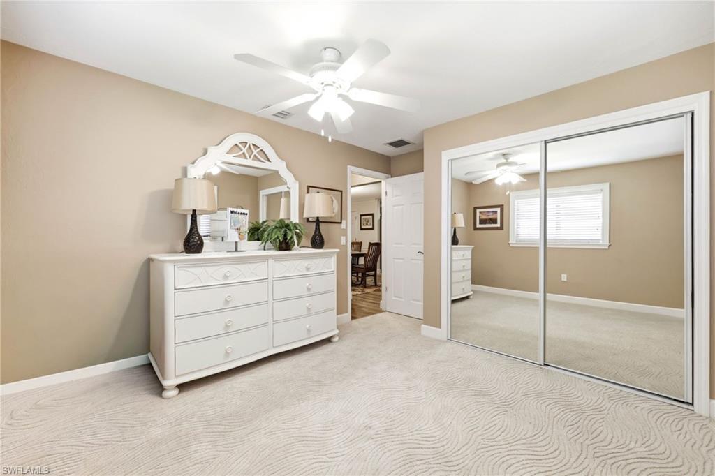 5201 31st Place Southwest Naples, FL 34116 - Photo 14 of 24 a room with a mirror and double vanity