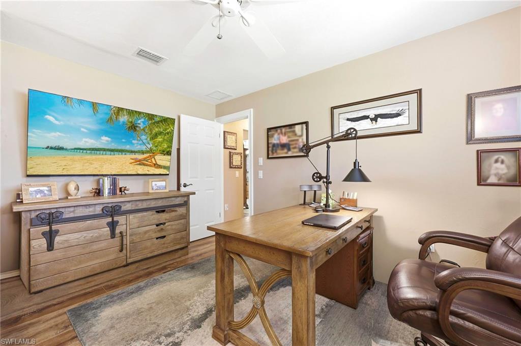 5201 31st Place Southwest Naples, FL 34116 - Photo 17 of 24 a room with furniture and flat screen tv