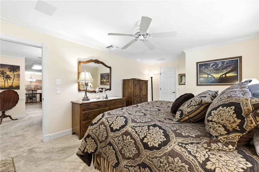 5201 31st Place Southwest Naples, FL 34116 - Photo 20 of 24 a bedroom with a bed and dresser