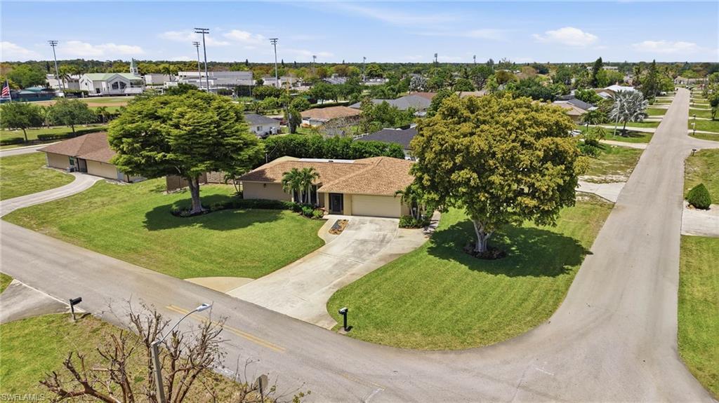 5201 31st Place Southwest Naples, FL 34116 - Photo 2 of 24 an aerial view of a house with yard lake and outdoor seating