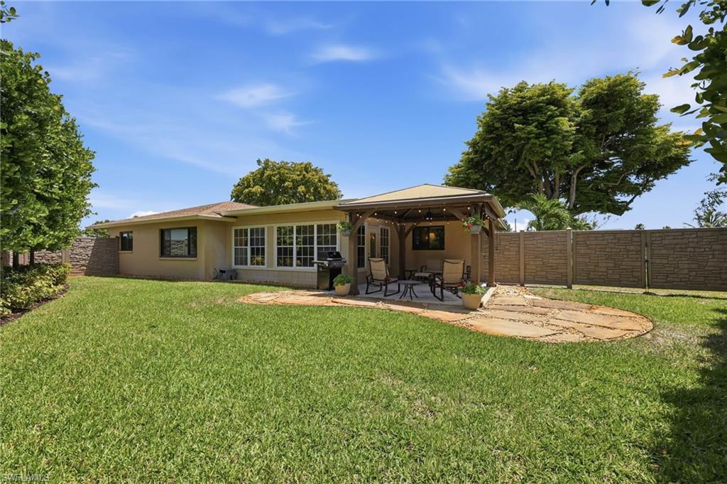 5201 31st Place Southwest Naples, FL 34116 - Photo 22 of 24 a view of a house with backyard sitting area and garden