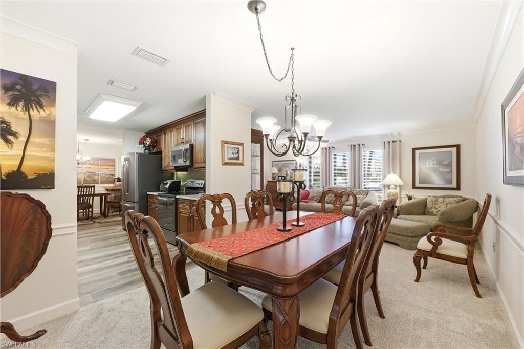 5201 31st Place Southwest Naples, FL 34116 - Photo 3 of 24 a view of a dining room with furniture window and wooden floor