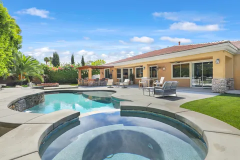 a view of a swimming pool with outdoor seating
