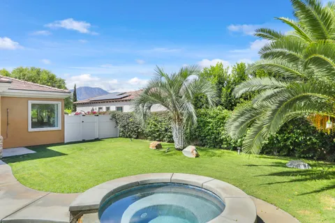 a view of a house with swimming pool and sitting area