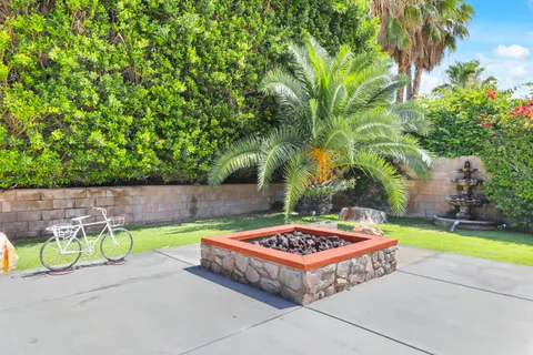 a view of a patio with couches table and chairs and potted plants