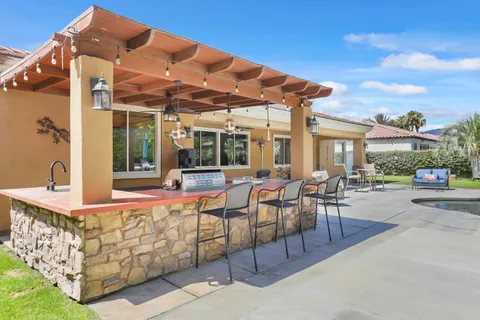 a view of a swimming pool with outdoor seating