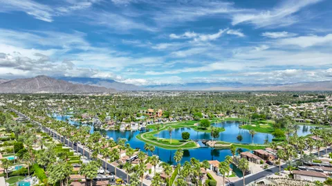 a view of a city with lush green yard