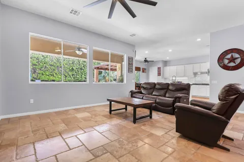 a living room with furniture and kitchen view