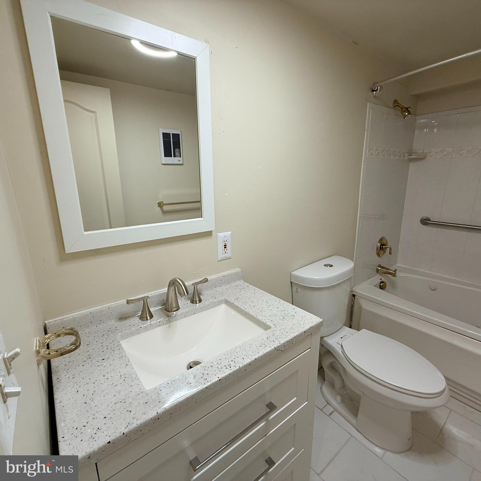33 Randolph Place Northwest, Unit B Washington, DC 20001 - Photo 14 of 23 a bathroom with a granite countertop sink mirror vanity and toilet