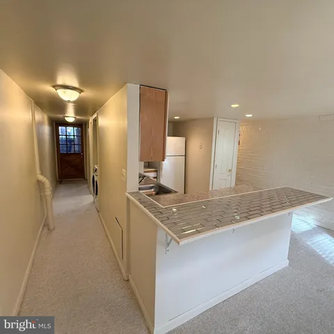 a kitchen with stainless steel appliances granite countertop a sink and a refrigerator