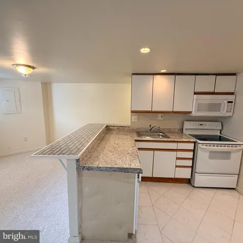 a kitchen with stainless steel appliances granite countertop a sink and a stove