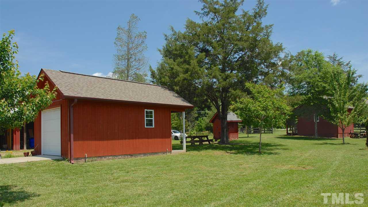 5390 Helena Moriah Road Rougemont, NC 27572 - Photo 23 of 25 Mowing shed with concrete ramp and automatic overhead door. Covered porch on opposite side.