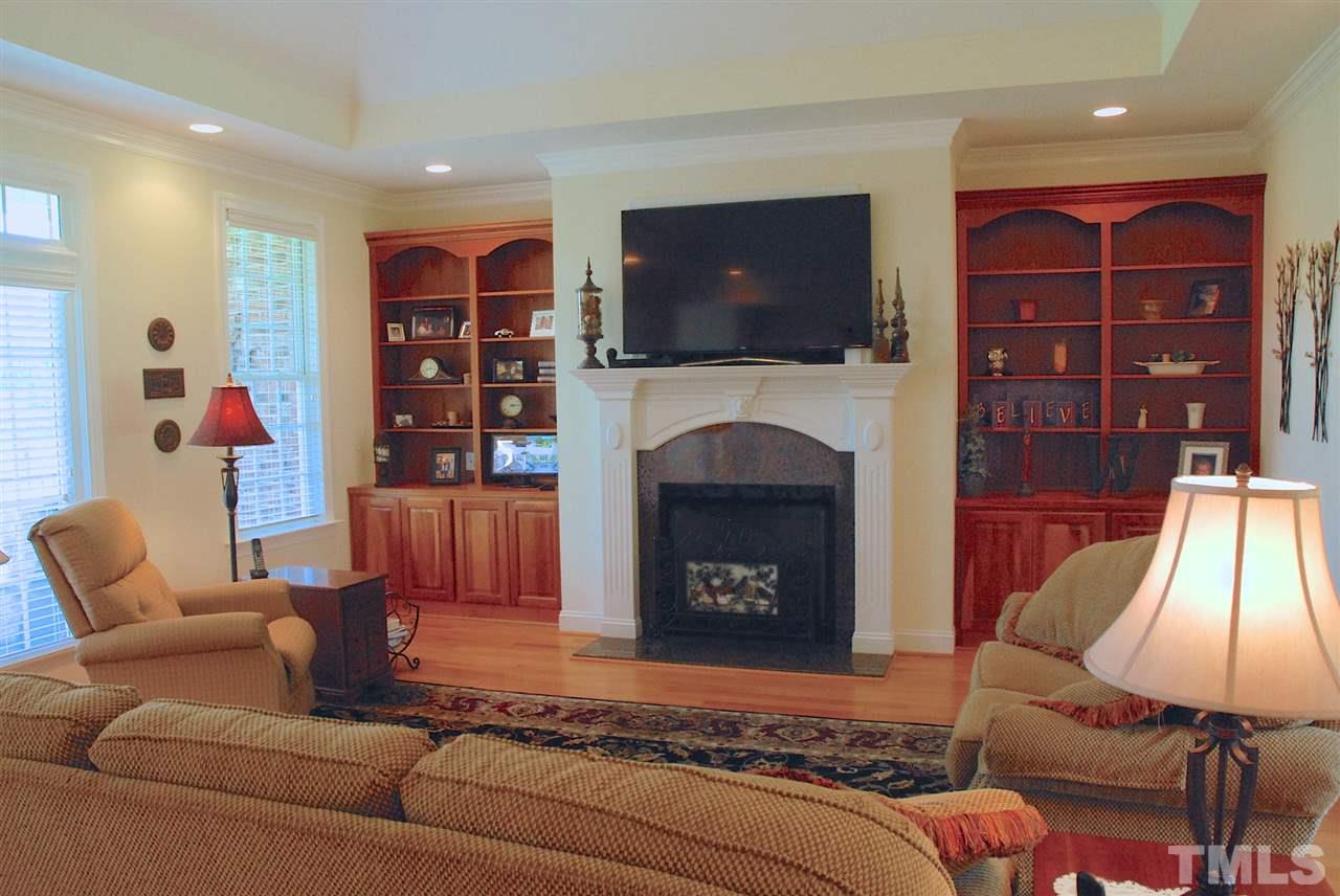 5390 Helena Moriah Road Rougemont, NC 27572 - Photo 9 of 25 Living room with vaulted ceiling, gas fireplace, built-in shelves, doors to covered porch, view of horse pasture and pond.
