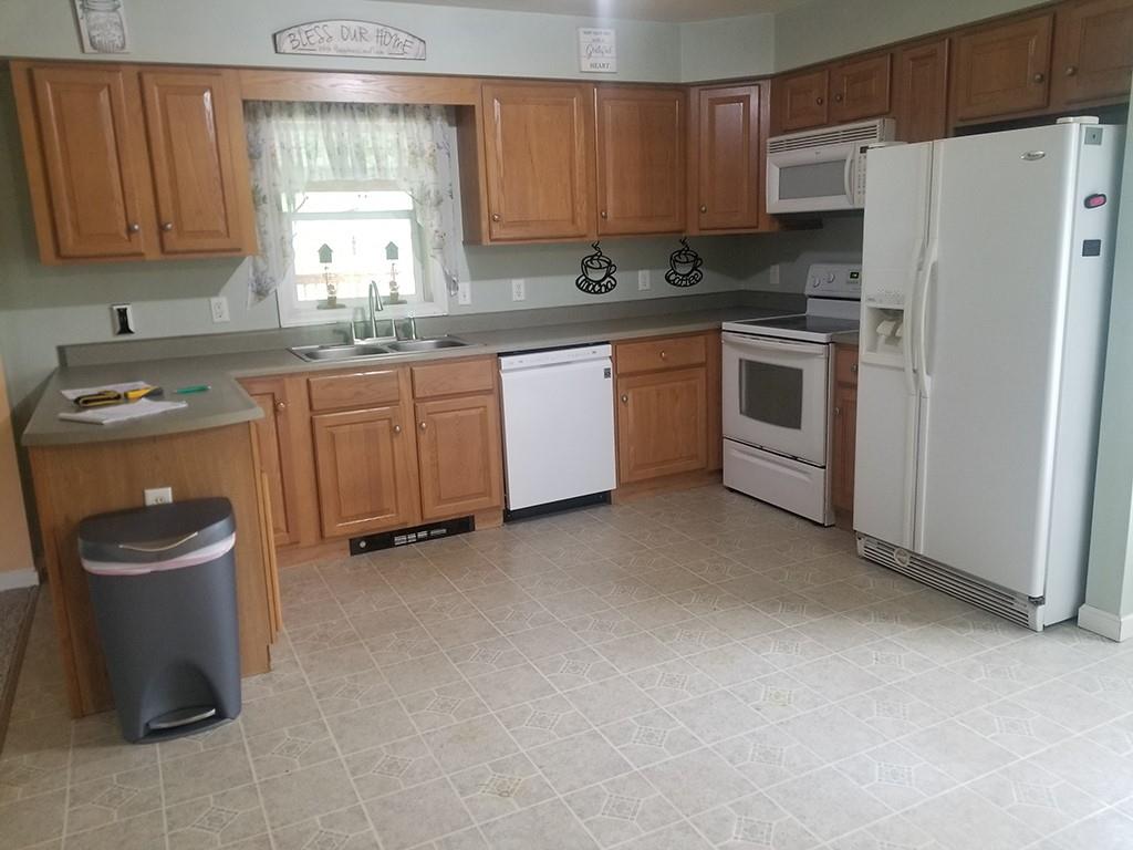 422 Stable Road Indiana, PA 15701 - Photo 7 of 32 a kitchen with a sink a stove and a refrigerator