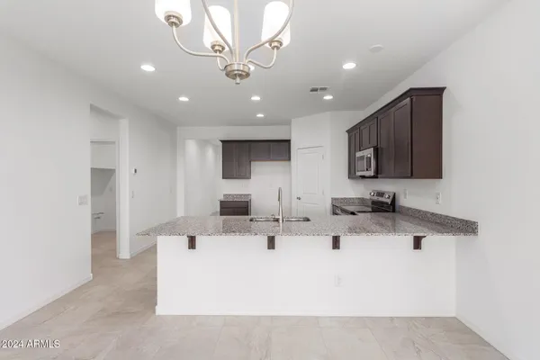 a view of a kitchen with a sink stainless steel appliances and cabinets