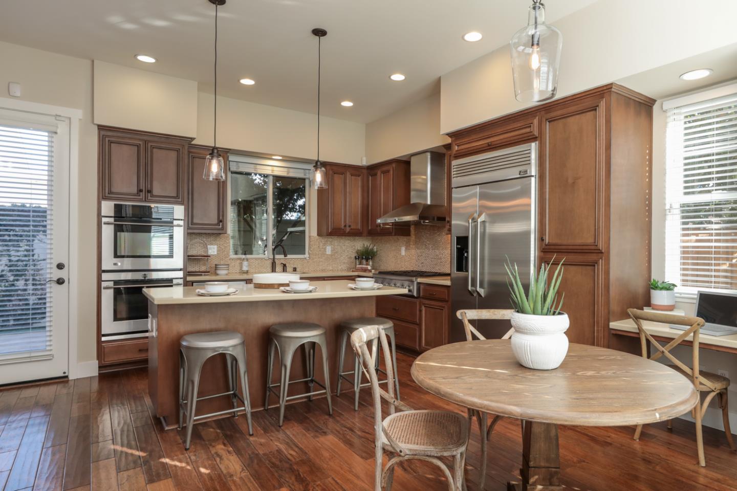 920 Rincon Street Mountain View, CA 94040 - Photo 14 of 45 a kitchen with a dining table chairs stainless steel appliances and cabinets