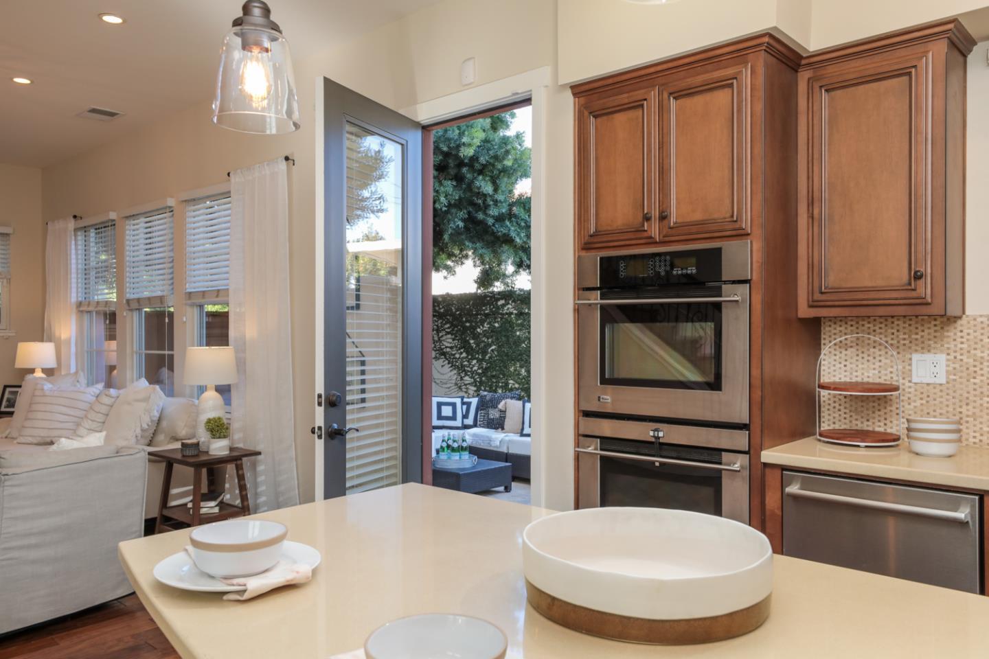 920 Rincon Street Mountain View, CA 94040 - Photo 17 of 45 a kitchen with stainless steel appliances a dining table and chairs