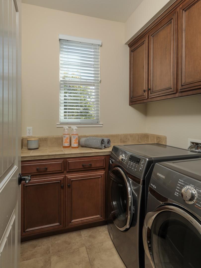 920 Rincon Street Mountain View, CA 94040 - Photo 27 of 45 a utility room with stainless steel appliances white cabinets washer and dryer
