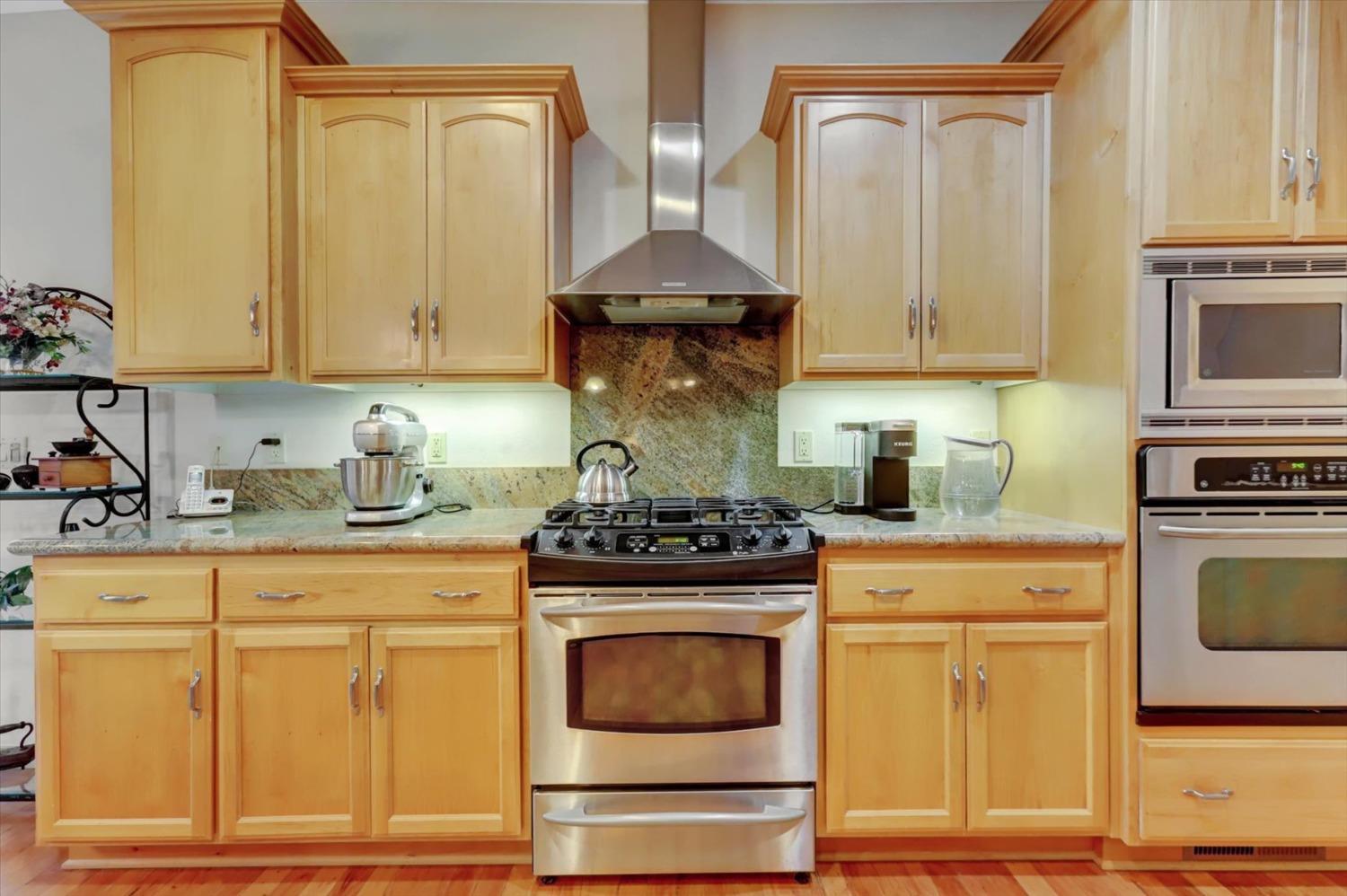 17036 Alice Way Grass Valley, CA 95949 - Photo 19 of 58 a kitchen with granite countertop white cabinets and stainless steel appliances