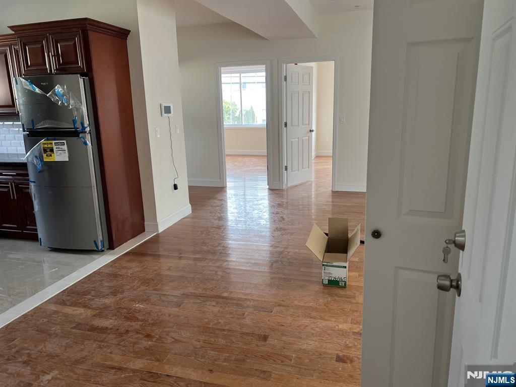 80-82 Madison Street Paterson, NJ 07501 - Photo 3 of 7 a view of a hallway with wooden floor and staircase
