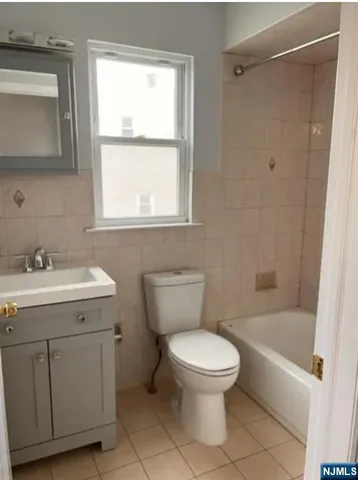 a white toilet sitting next to a bathroom sink