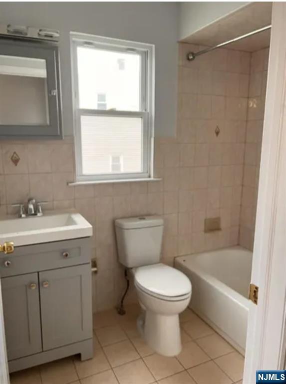 80-82 Madison Street Paterson, NJ 07501 - Photo 5 of 7 a white toilet sitting next to a bathroom sink