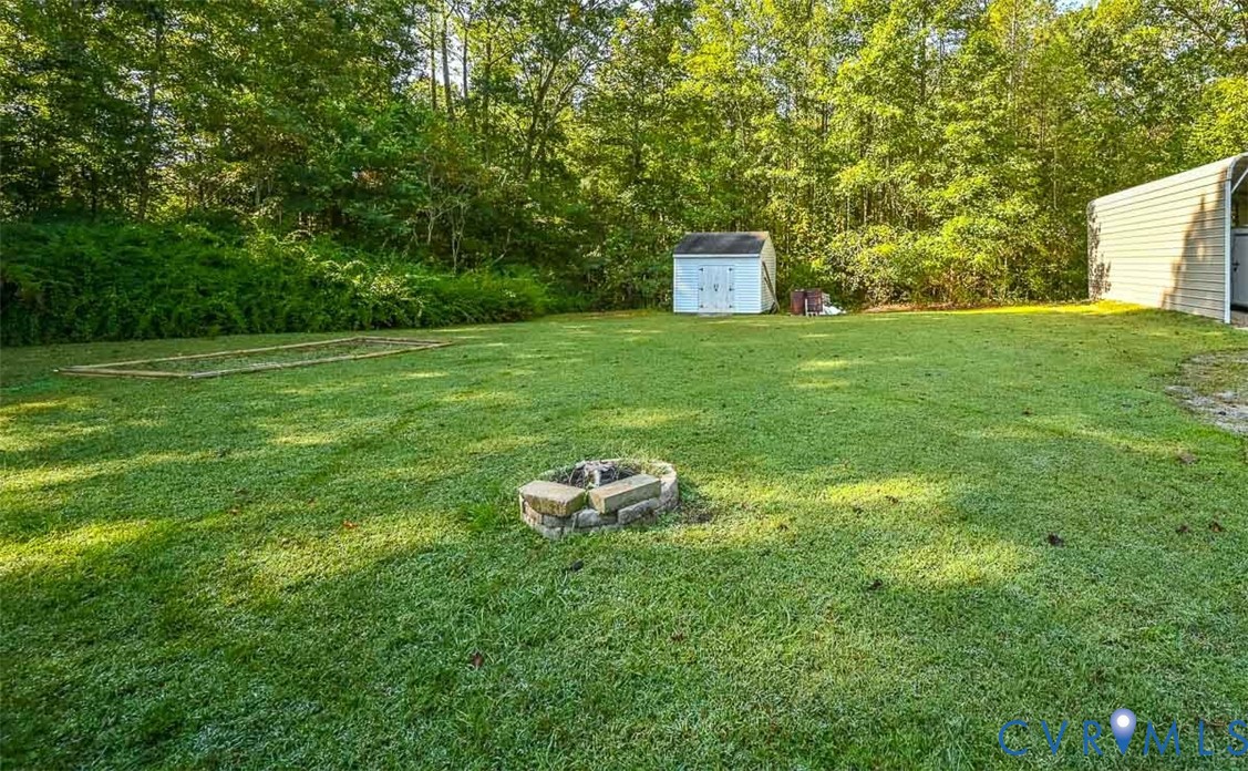 8968 King William Road Aylett, VA 23009 - Photo 16 of 17 View of grassy yard with a storage shed and an out