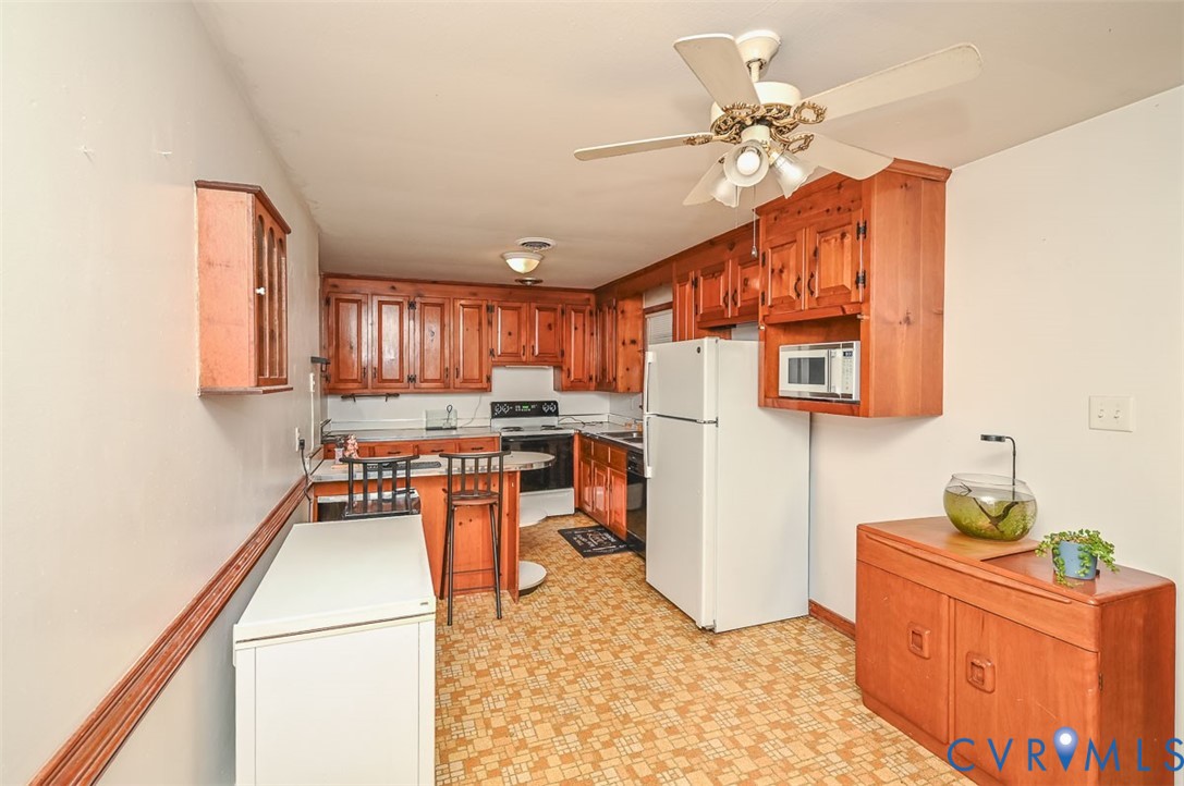 8968 King William Road Aylett, VA 23009 - Photo 3 of 17 Kitchen featuring white appliances, a breakfast ba