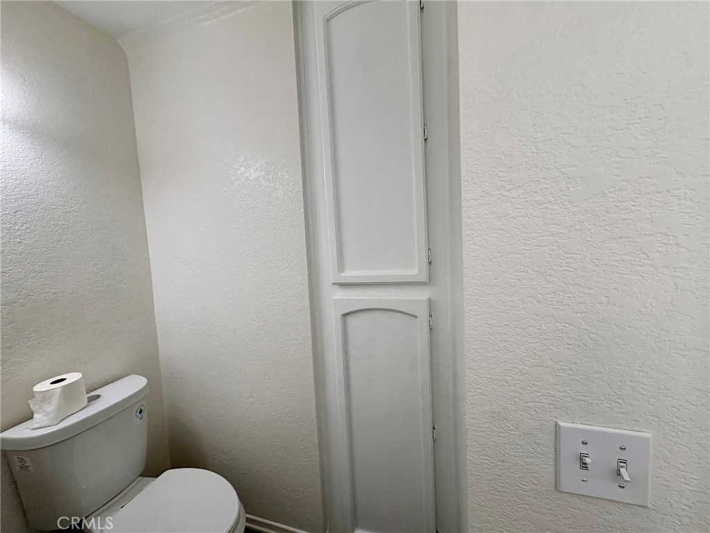 7280 Comiso Way Rancho Cucamonga, CA 91701 - Photo 30 of 66 a white toilet sitting next to a white wall