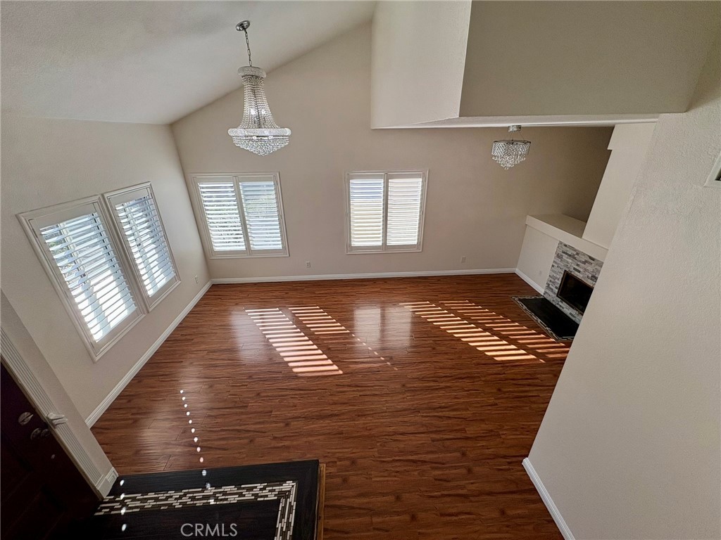 7280 Comiso Way Rancho Cucamonga, CA 91701 - Photo 33 of 66 a view of an empty room with wooden floor and windows