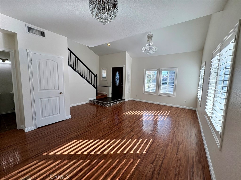 7280 Comiso Way Rancho Cucamonga, CA 91701 - Photo 4 of 66 a view of a livingroom with wooden floor and window