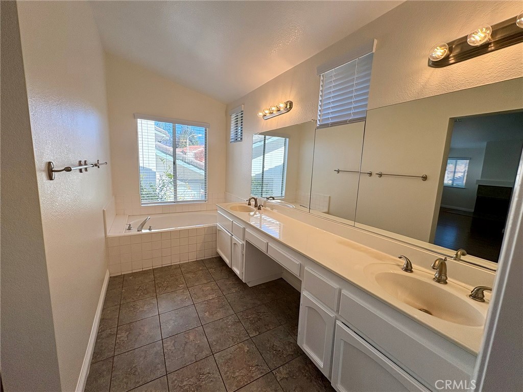 7280 Comiso Way Rancho Cucamonga, CA 91701 - Photo 41 of 66 a bathroom with a double vanity sink a mirror and a bathtub