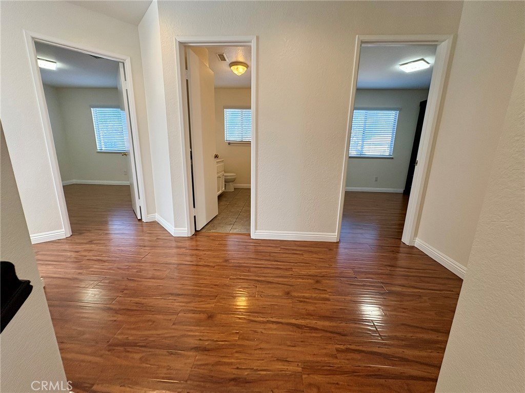 7280 Comiso Way Rancho Cucamonga, CA 91701 - Photo 49 of 66 a view of a hallway with wooden floor and closet